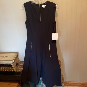 Cute black mid length dress with zipper pockets